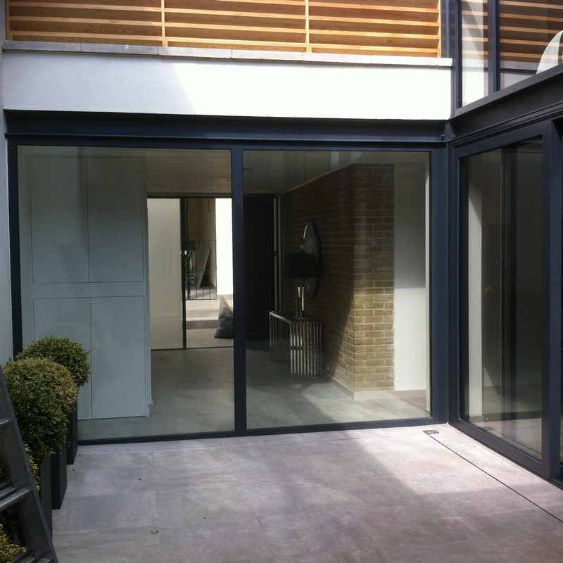 Floor-to-ceiling sliding doors opening to courtyard in Stockwell