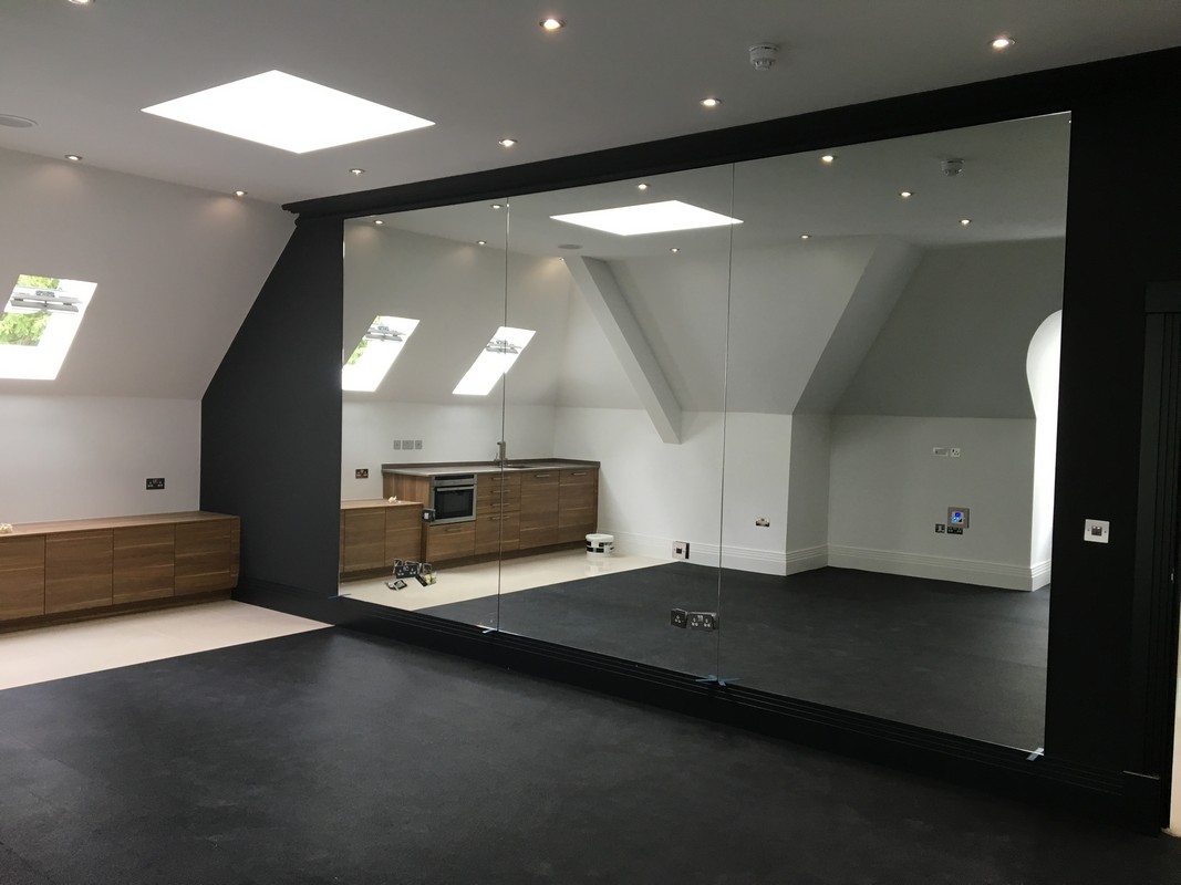 Frameless glass wall dividing loft conversion in Stockwell