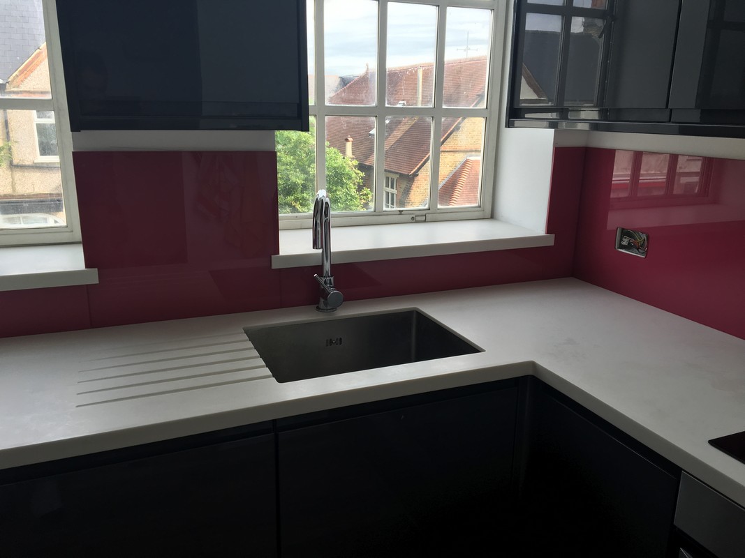 Deep plum coloured glass splashback in modern Stockwell kitchen